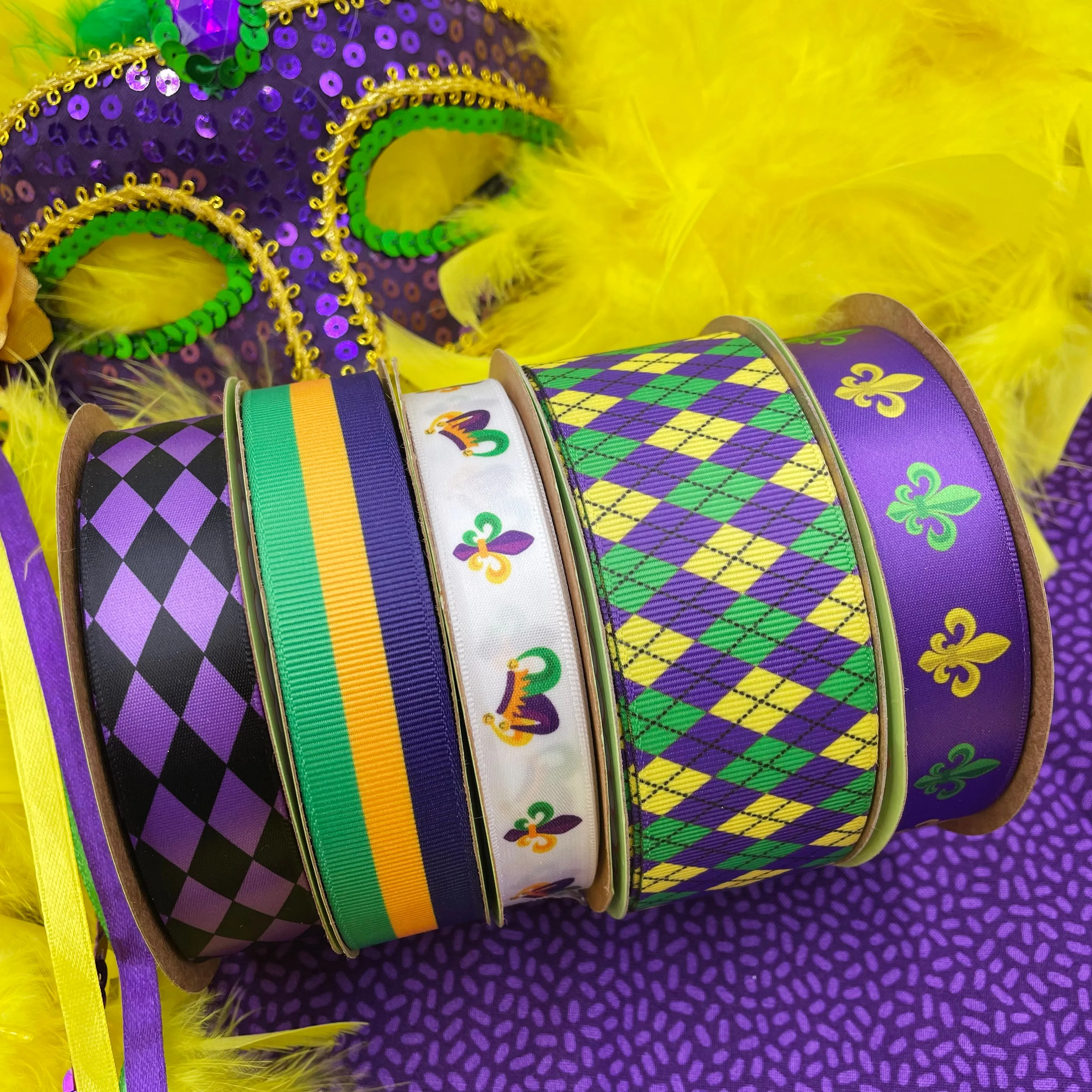 Mardi Gras ribbon with French fleur de lIs in green and yellow on a purple background printed on 7/8" white grosgrain and satin